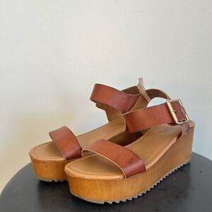Brown leather platform wedge sandal with wooden sole by Soda. Women’s size 6